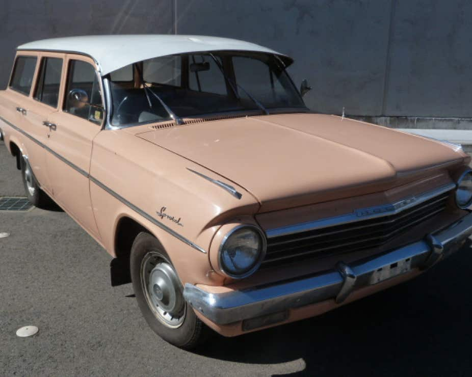 An old Holden pale pink station wagon